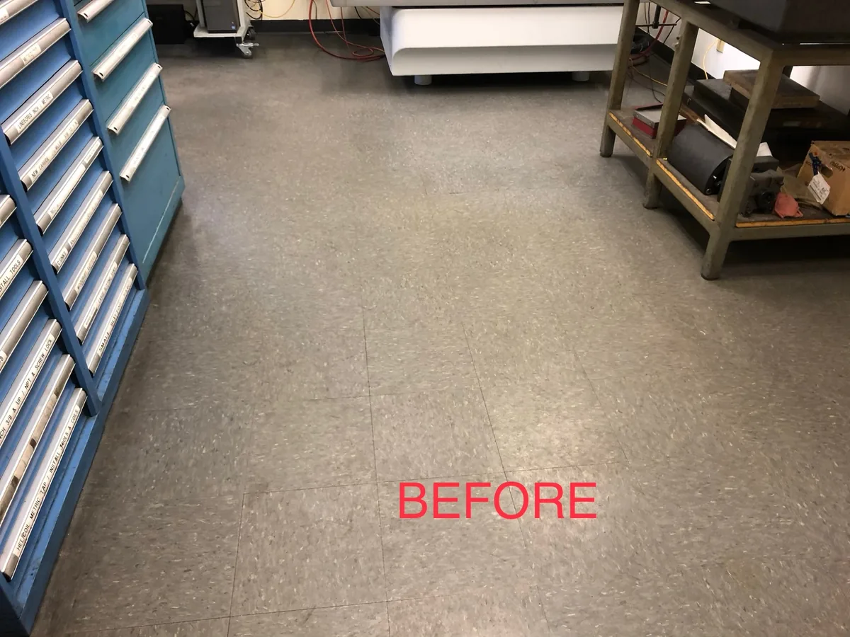 Dull worn VCT floor in a shop before stripping